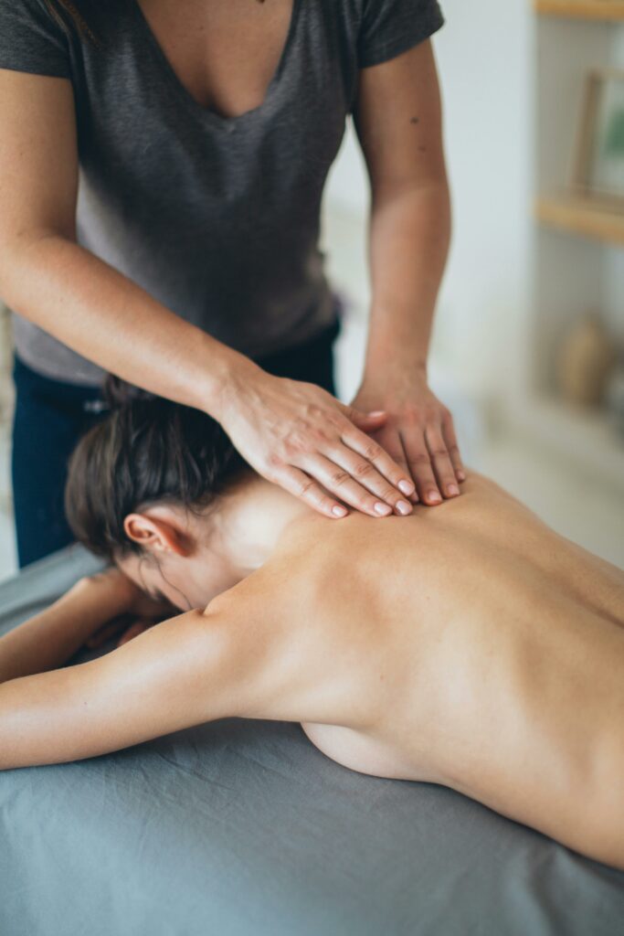 A professional masseur performs a calming massage on a client, promoting relaxation and well-being.
